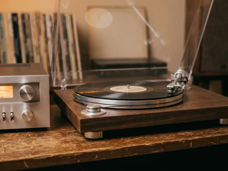 Vintage turntable next to a silver receiver